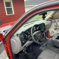 The same truck cab after detailing, with clean carpet, dash and door panel