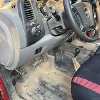 Truck cab interior with heavily soiled carpet and dusty dash before detailing