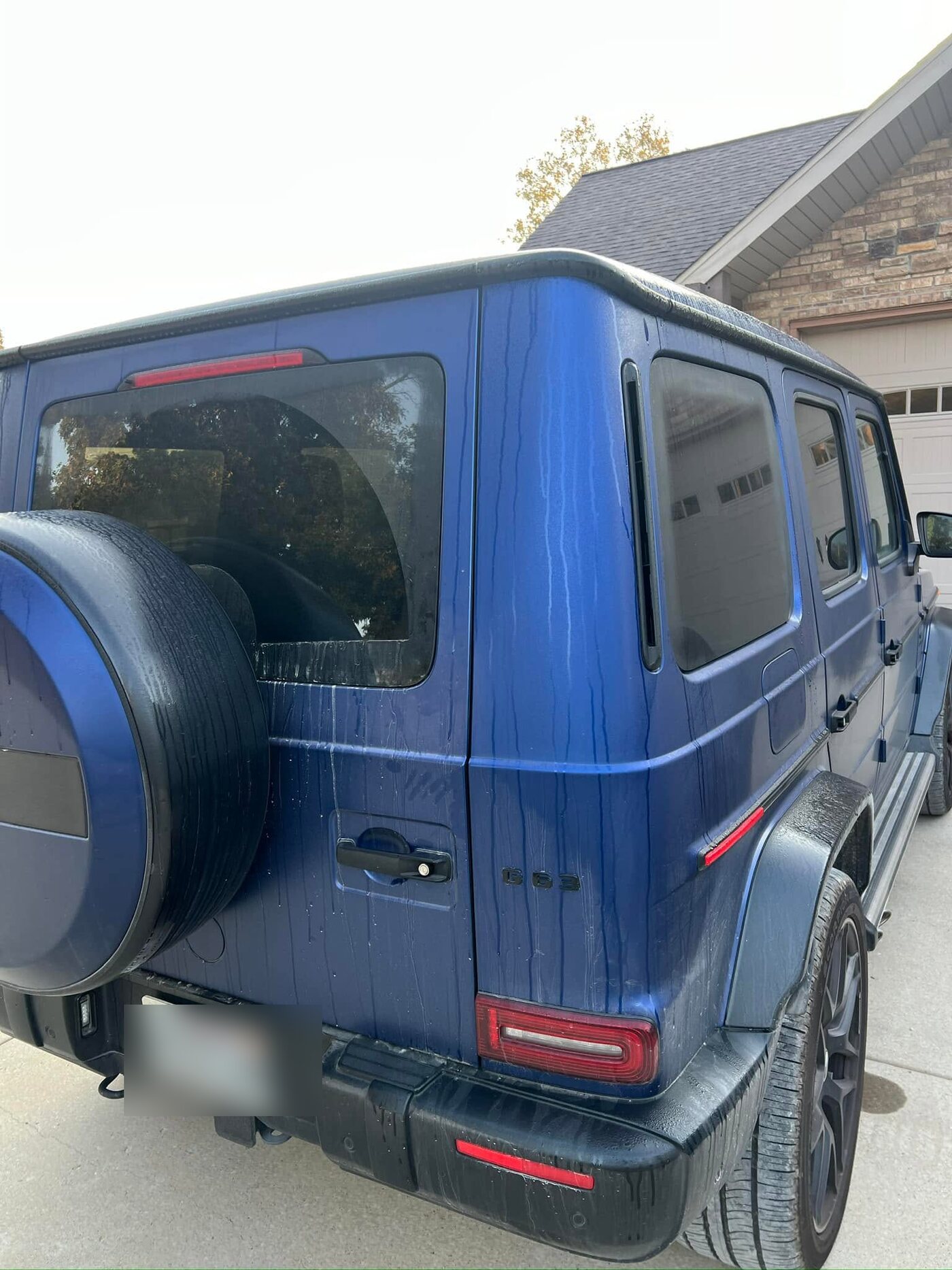 Blue Mercedes-AMG G63 during a foam hand wash